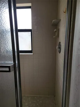 a bathroom with a glass shower door