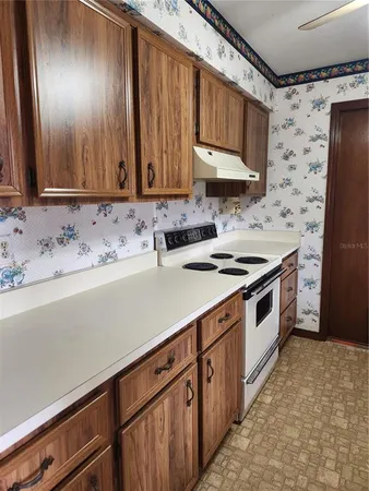 a kitchen with a sink stove and cabinets