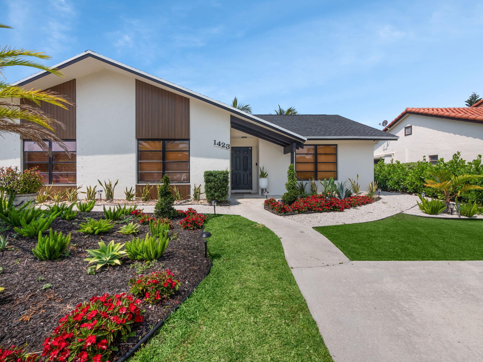 a front view of house with a yard and outdoor seating