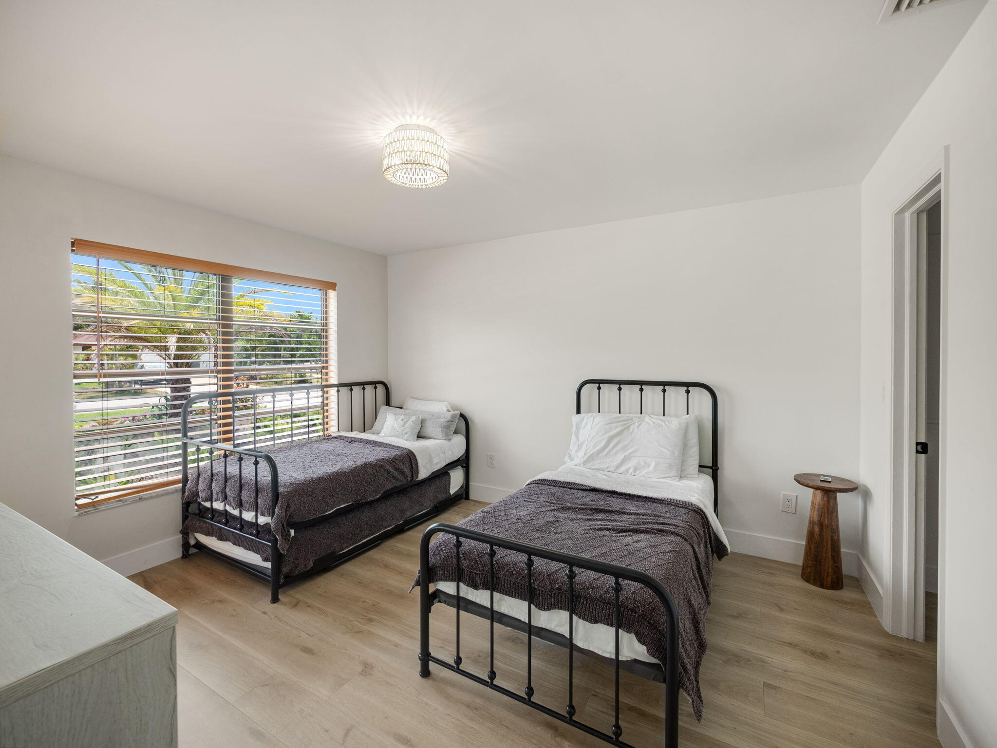 1423 Riverside Circle Wellington, FL 33414 - Photo 11 of 29 a spacious bedroom with two beds and wooden floor