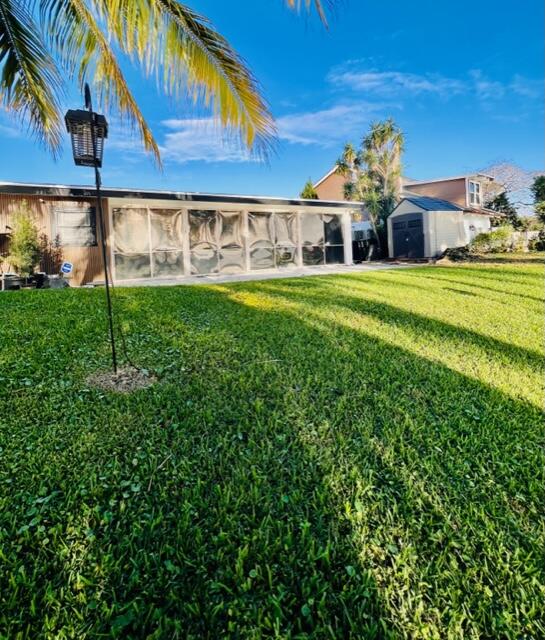 1423 Riverside Circle Wellington, FL 33414 - Photo 4 of 29 a front view of a house with garden