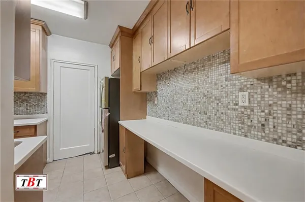 a bathroom with a sink and a refrigerator