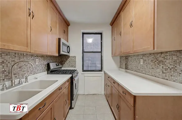 a kitchen with a sink stove and cabinets