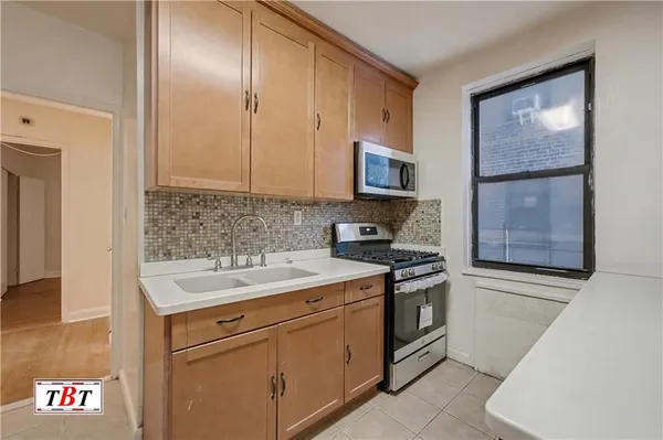 a kitchen with a sink stove and cabinets