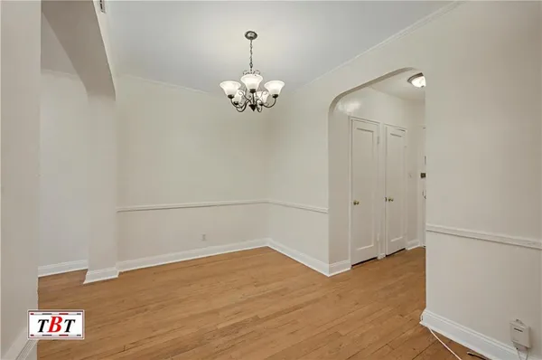 a view of a room with wooden floor