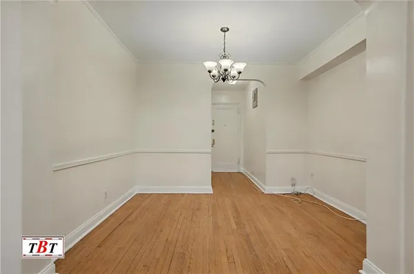 a view of a room with wooden floor and ceiling fan
