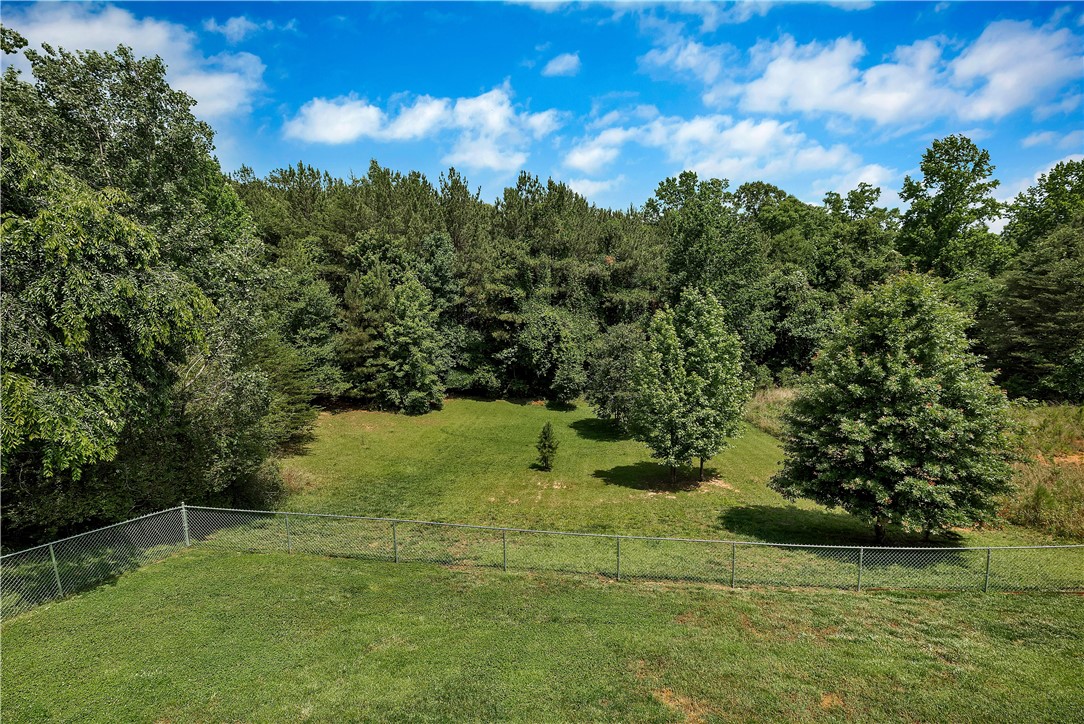 131 Morgan Road West Union, SC 29696 - Photo 22 of 39 A tranquil, partially fenced yard offers a lush green space backed by a dense line of trees.