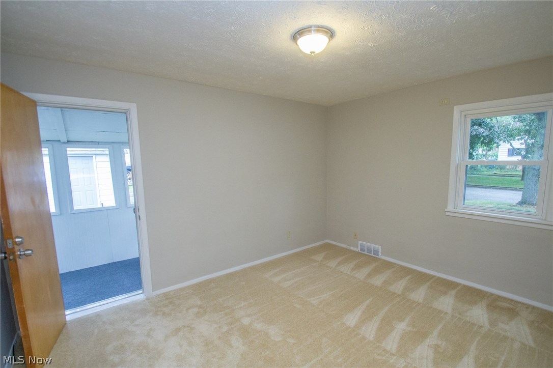 10571 Snow Road Parma Heights, OH 44130 - Photo 14 of 25 Bedroom 3 with newer carpet and sun porch access