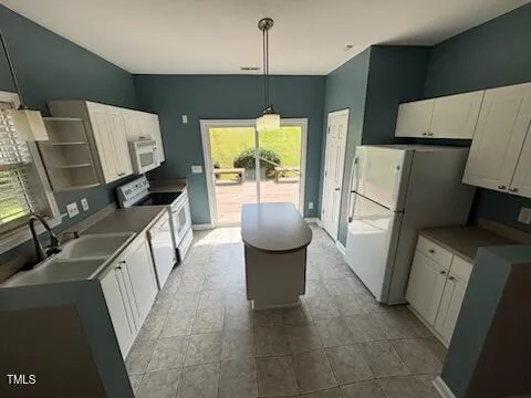 a kitchen with a refrigerator and a stove