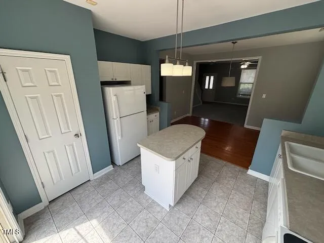 a kitchen with a refrigerator a sink and a stove