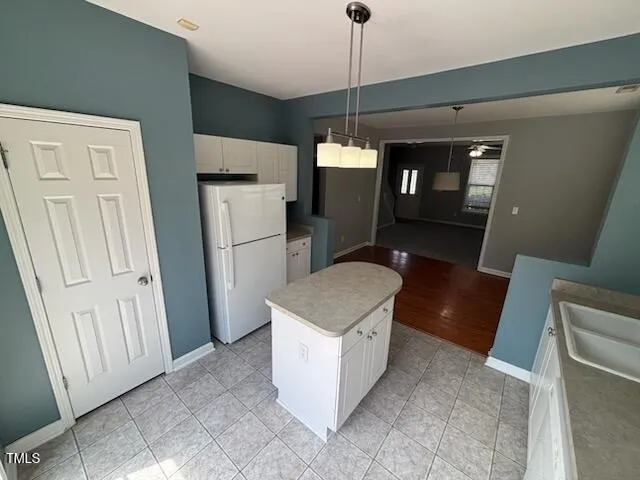 a kitchen with stainless steel appliances granite countertop a refrigerator a sink and a stove