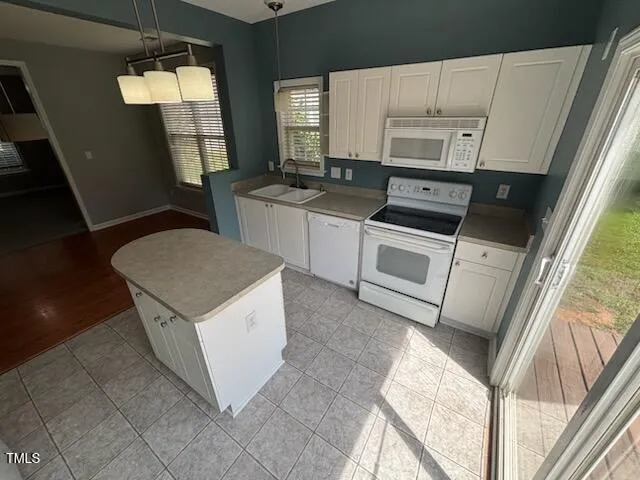 a kitchen with a stove a sink and a microwave