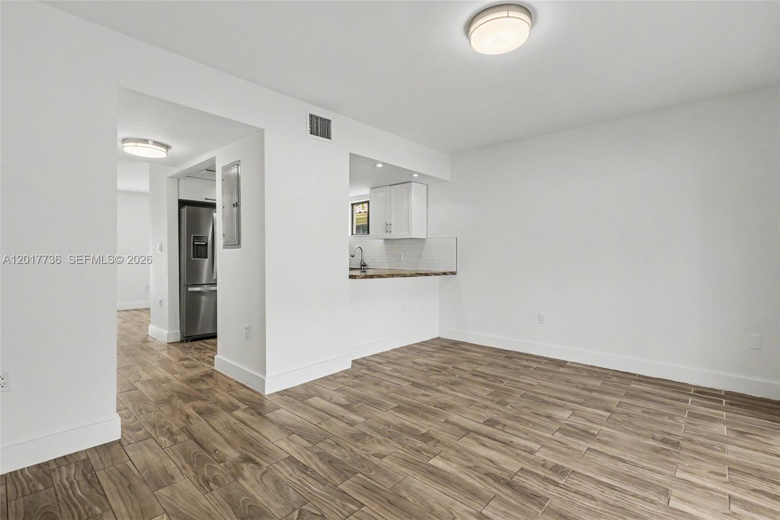 122 Southwest 56th Avenue Miami, FL 33144 - Photo 19 of 48 a view of empty room with wooden floor