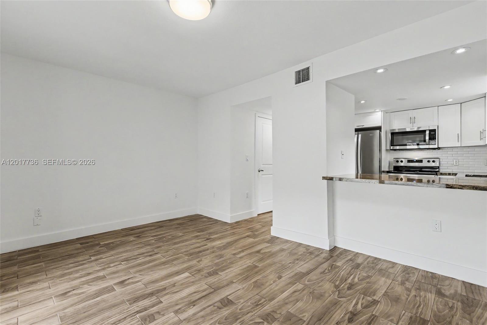 122 Southwest 56th Avenue Miami, FL 33144 - Photo 20 of 48 a view of a kitchen with wooden floor and electronic appliances