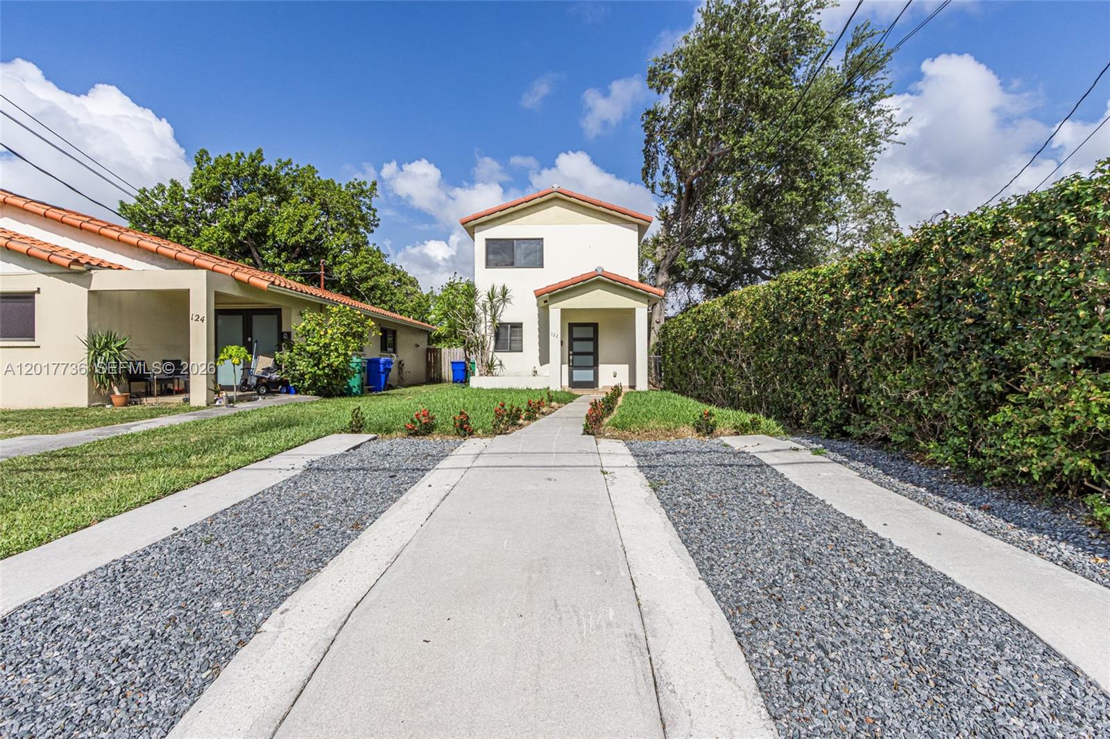 122 Southwest 56th Avenue Miami, FL 33144 - Photo 2 of 48 a front view of a house with a yard and potted plants