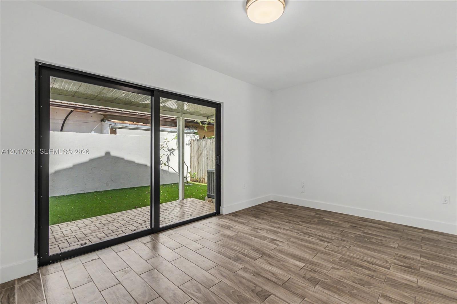122 Southwest 56th Avenue Miami, FL 33144 - Photo 23 of 48 a view of empty room with wooden floor and fan