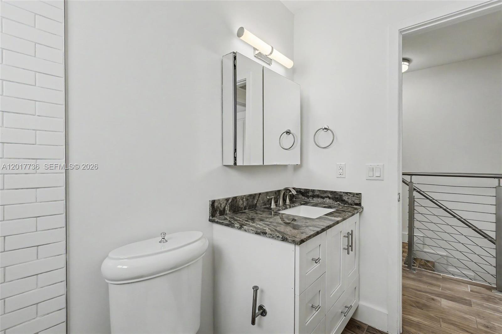 122 Southwest 56th Avenue Miami, FL 33144 - Photo 31 of 48 a bathroom with a granite countertop sink and a mirror