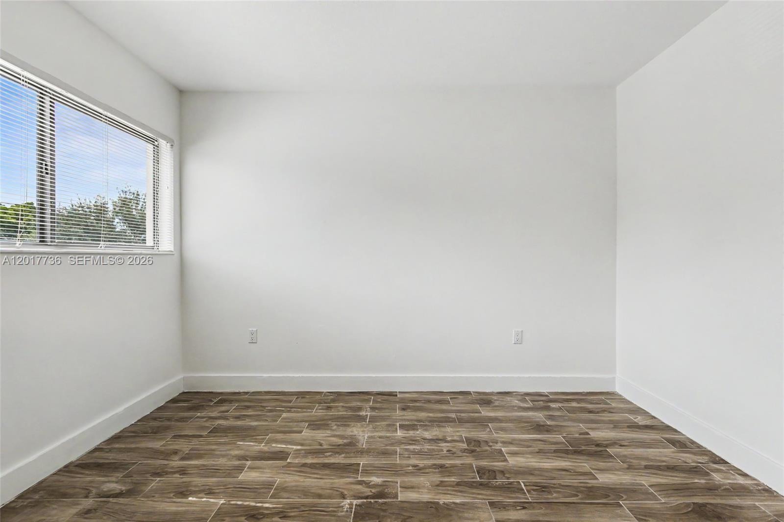 122 Southwest 56th Avenue Miami, FL 33144 - Photo 35 of 48 a view of a room with wooden floor and window