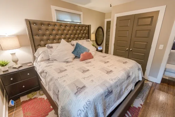 a bedroom with a bed and wooden floor