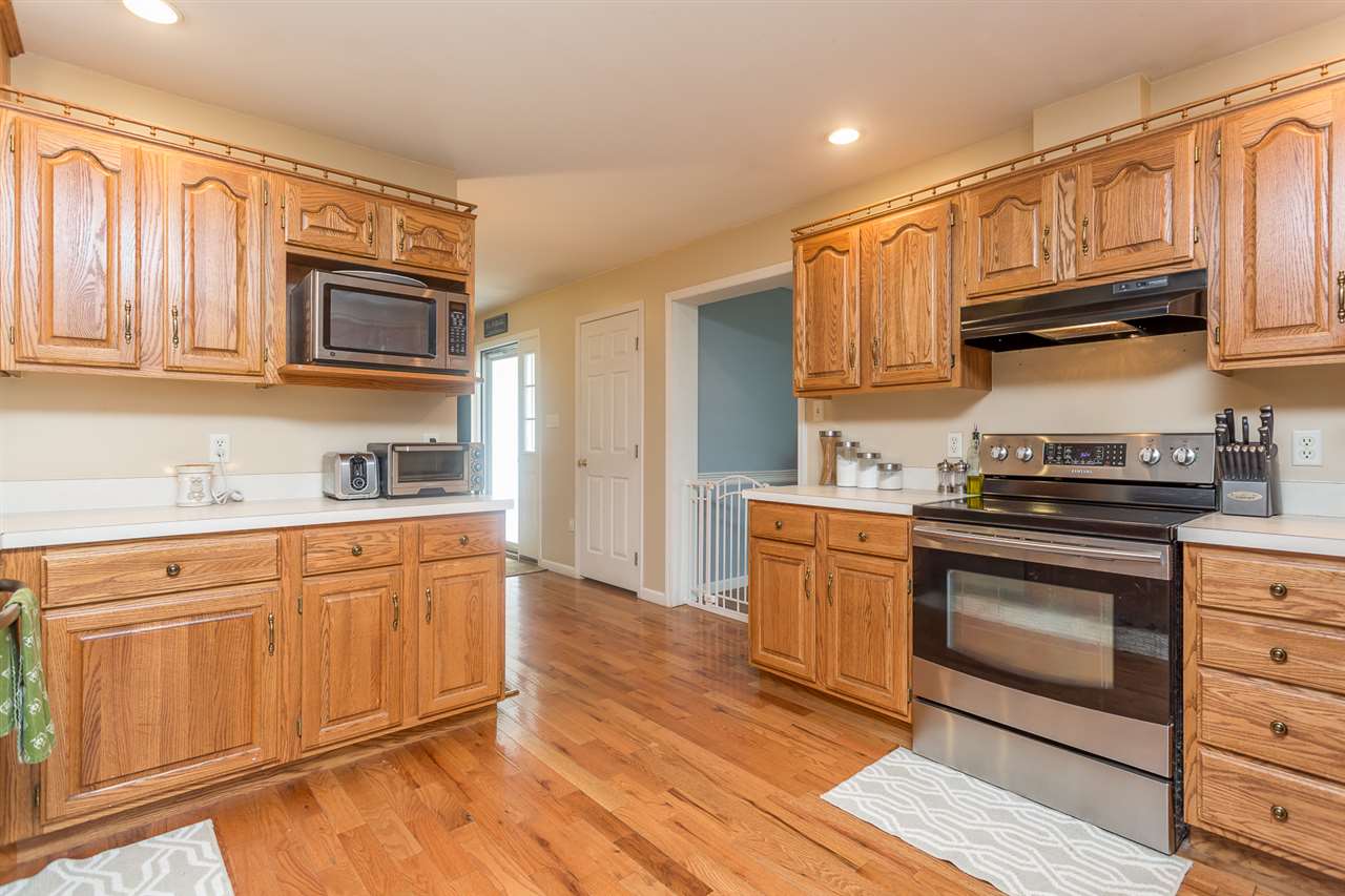 10882 Cook Town Road Bridgewater, VA 22812 - Photo 6 of 47 a kitchen with granite countertop cabinets stainless steel appliances and wooden floor