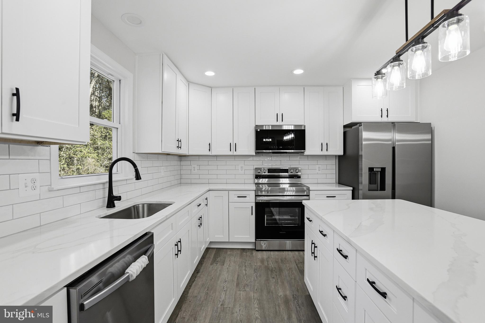 826 South Glebe Road Montross, VA 22520 - Photo 15 of 37 a kitchen with a sink white cabinets and stainless steel appliances