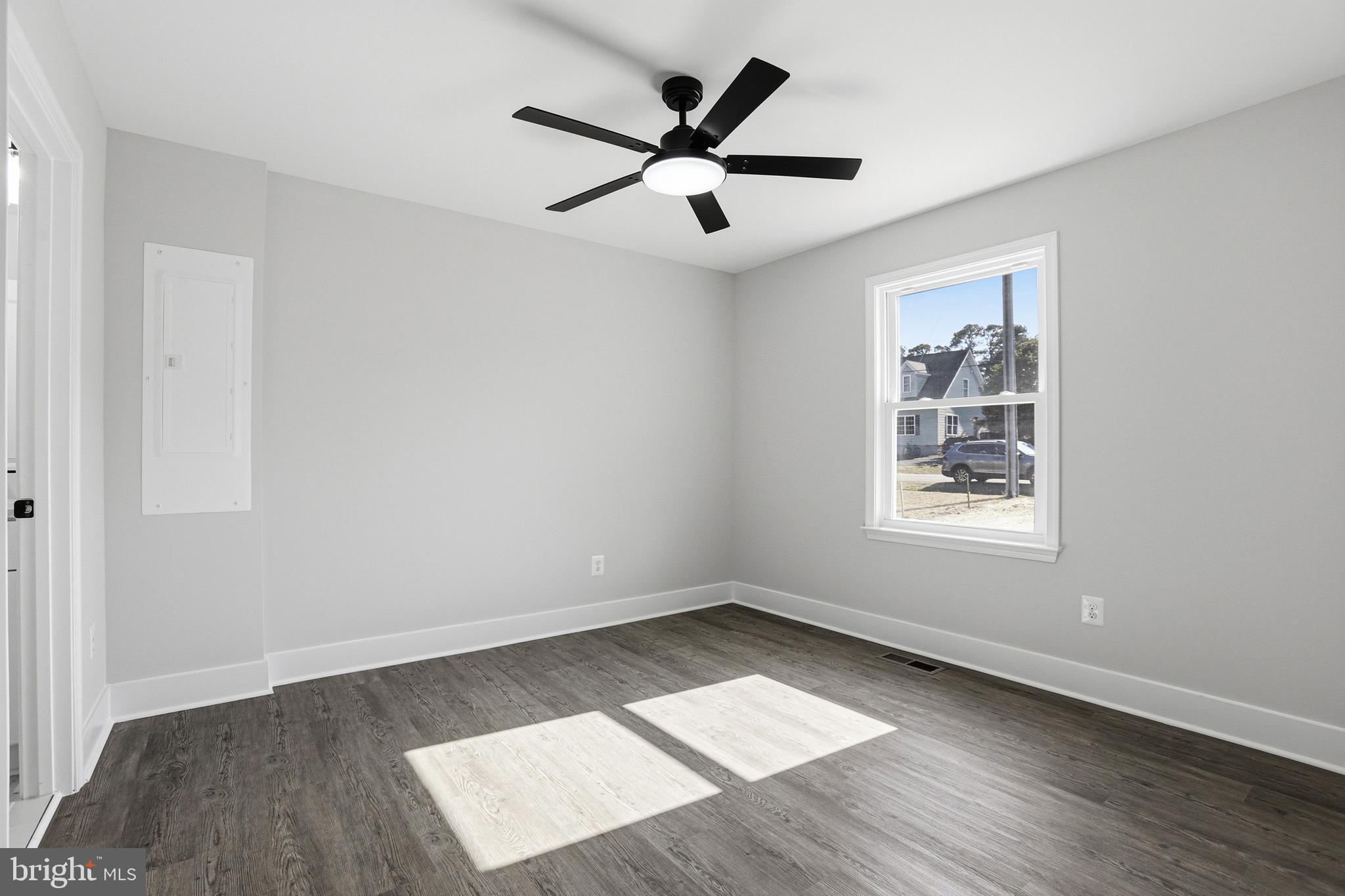 826 South Glebe Road Montross, VA 22520 - Photo 20 of 37 an empty room with wooden floor ceiling fan and windows