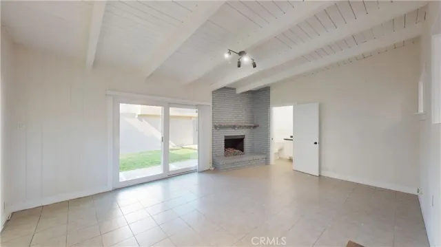 a view of a livingroom with a fireplace and window