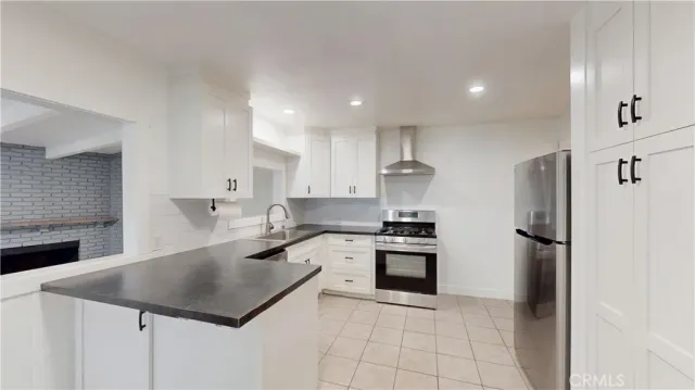 a kitchen with a stove a refrigerator and a sink