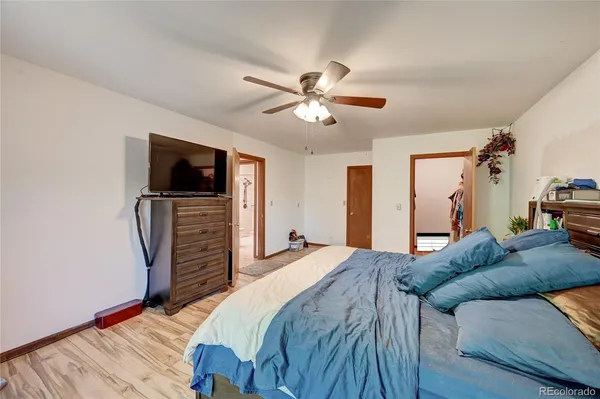 a bedroom with a bed and a television