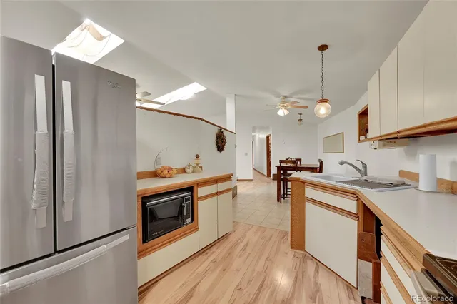 a kitchen with stainless steel appliances granite countertop a sink a stove and a refrigerator