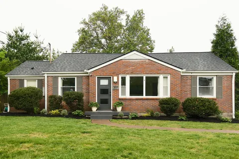 a front view of a house with a garden