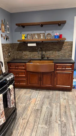 a kitchen with stainless steel appliances granite countertop a stove and a wooden cabinets