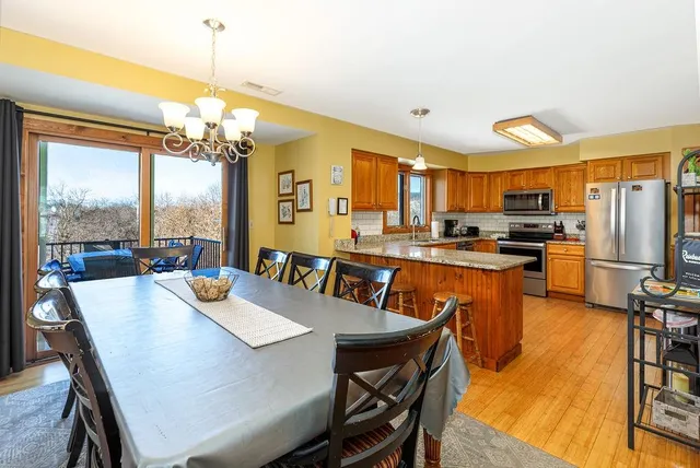 a kitchen with stainless steel appliances granite countertop a refrigerator stove top oven a sink and dishwasher