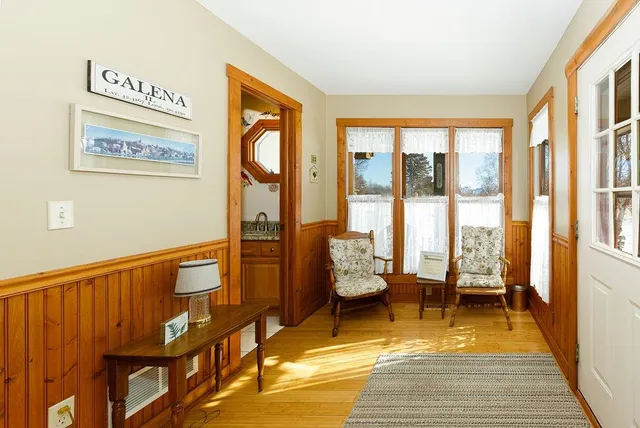 a view of a city from a dining room with furniture and wooden floor