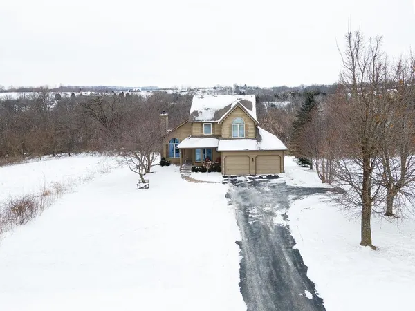 a view of a wooden bench sitting in backyard of house