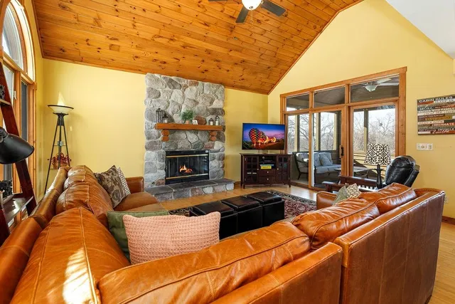 a living room with furniture and a floor to ceiling window