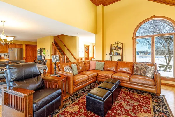 a living room with furniture floor to ceiling window and a flat screen tv