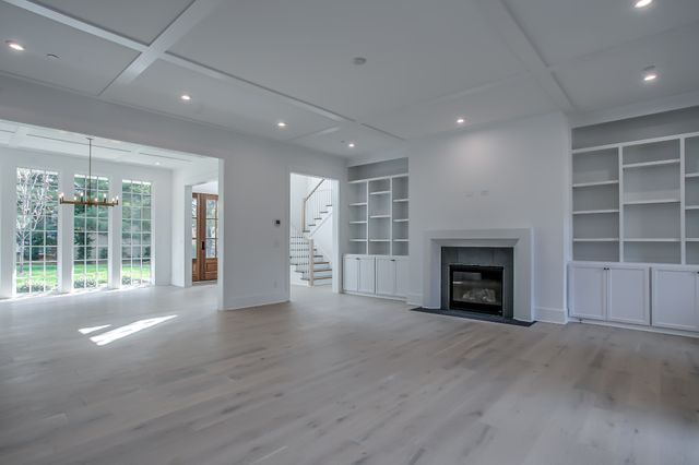 a large kitchen with kitchen island a large counter top space a sink stainless steel appliances and cabinets