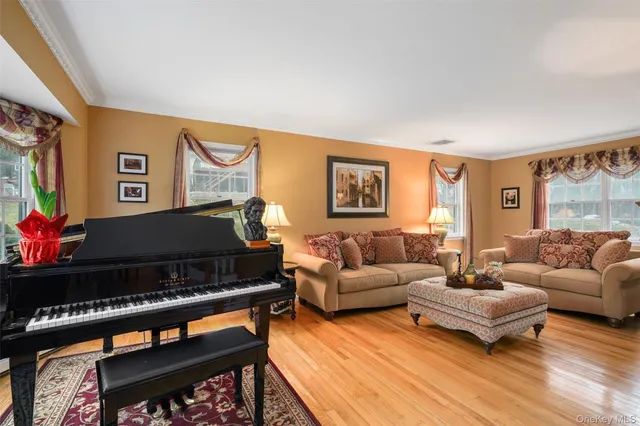 a living room with furniture and paintings on the wall