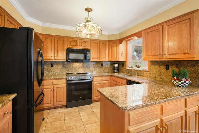 a kitchen with stainless steel appliances granite countertop a stove refrigerator sink and cabinets