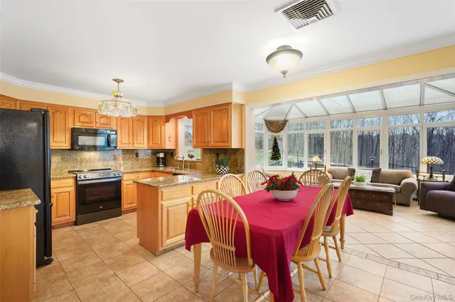 a large kitchen with a table chairs stove and refrigerator
