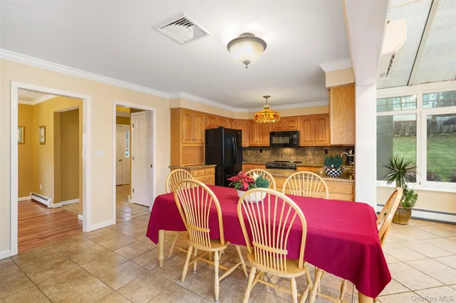a view of a dining room with furniture a chandelier and wooden floor