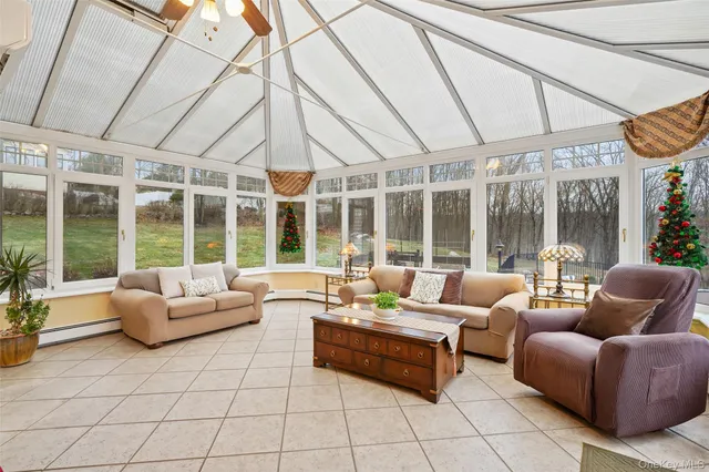 a living room with furniture and floor to ceiling windows