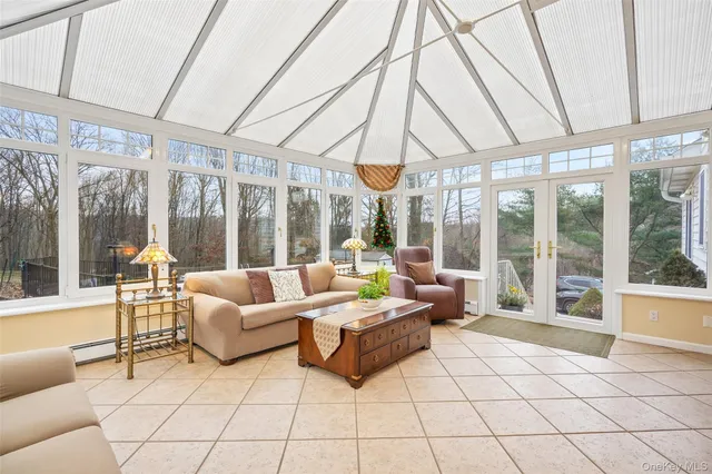 a living room with furniture and large windows