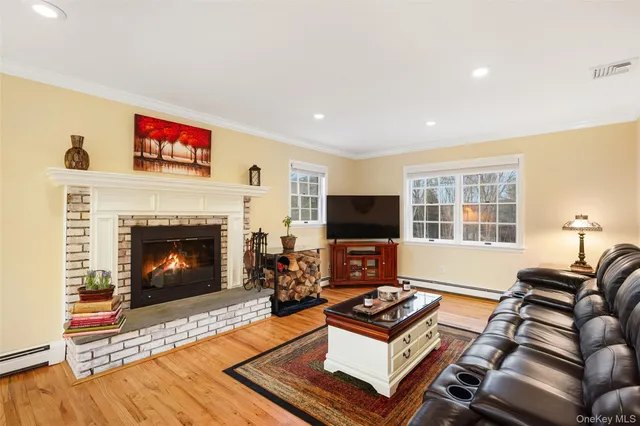 a living room with furniture a flat screen tv and a fireplace