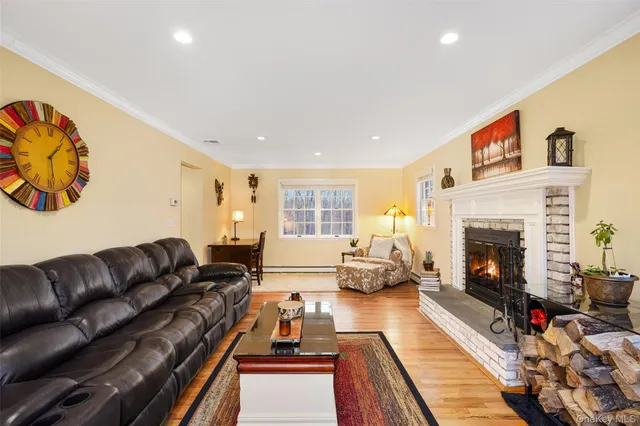 a living room with furniture fireplace and rug