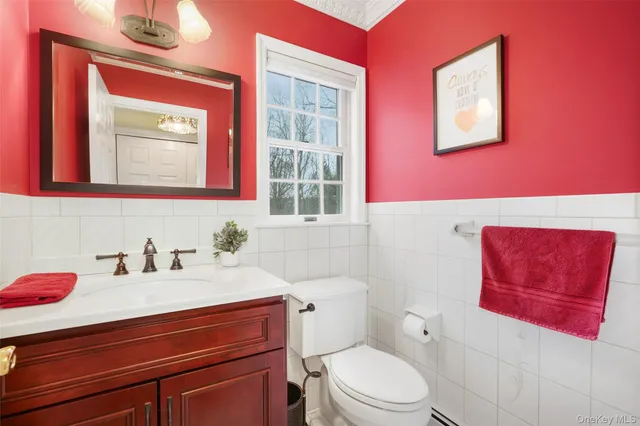 a bathroom with a sink mirror vanity and toilet