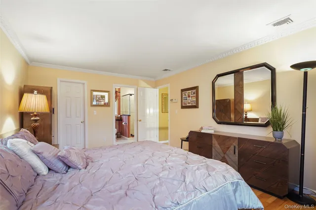 a bedroom with a large bed and a dresser