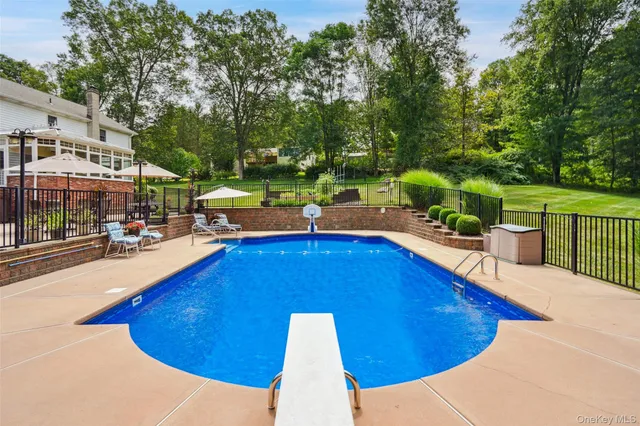 a view of a swimming pool with chairs