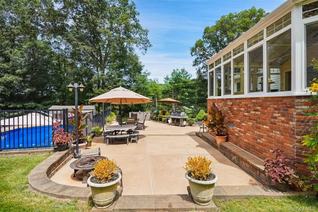a view of a swimming pool with a patio and a garden